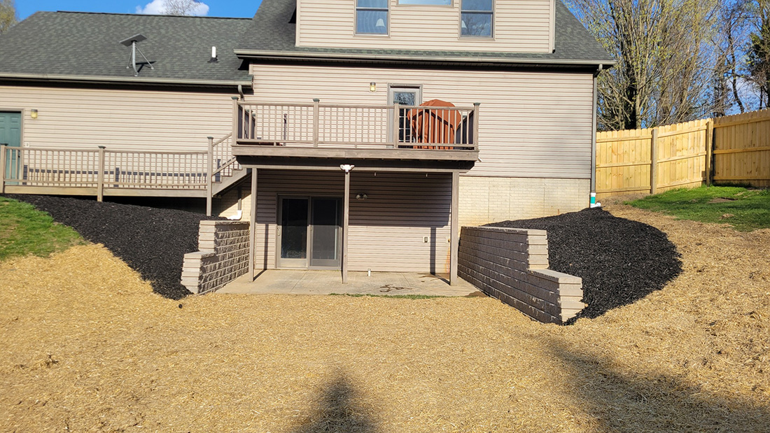 Custom limestone retaining wall with integrated stone steps, Jackson MI landscaping