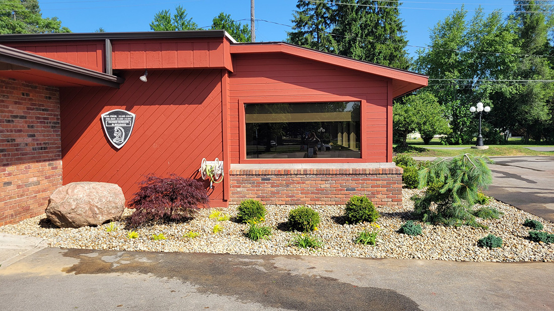 Commercial building landscaping with river rock beds and Japanese maple, Jackson MI