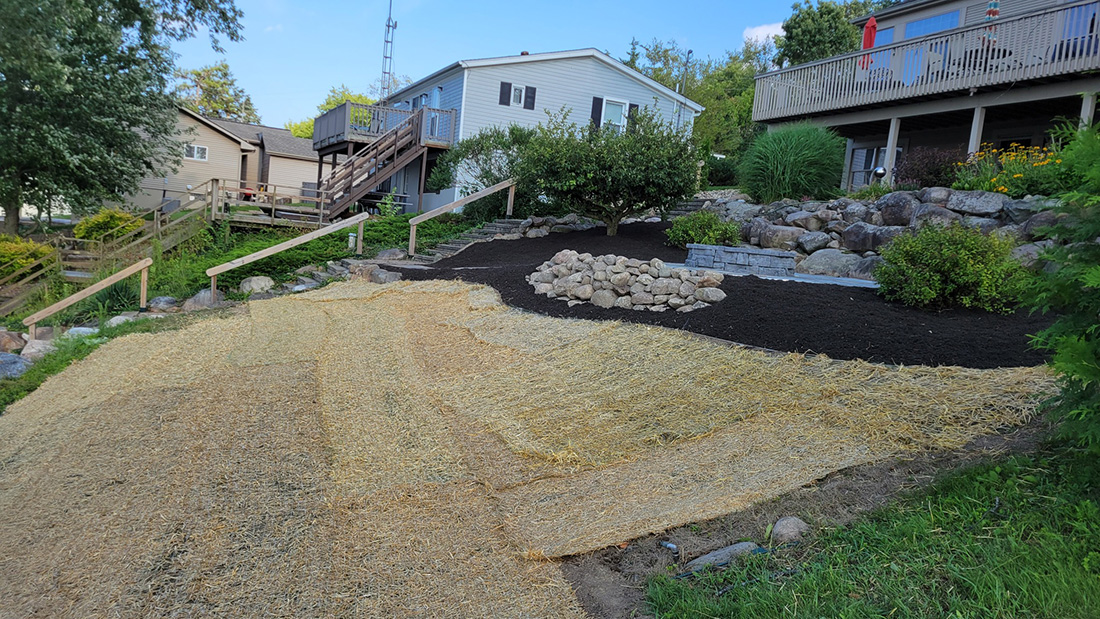 After lakefront slope and mulch beds